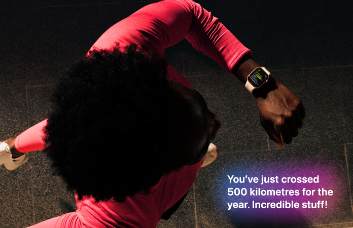 A person checks progress on Apple Watch Series 11 Workout app while running.