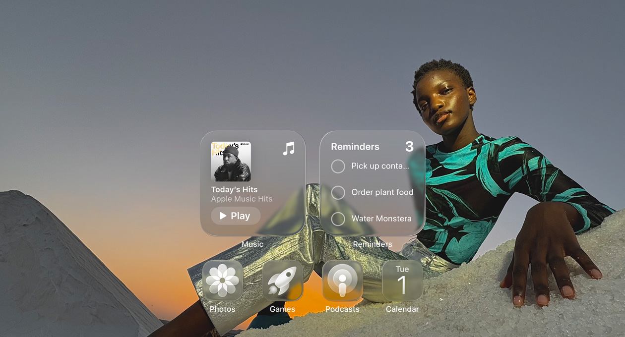 Liquid Glass display with clear app icons, like Apple Music, Reminders, Photos, Games, Podcasts, and Calendar refracting against the wallpaper