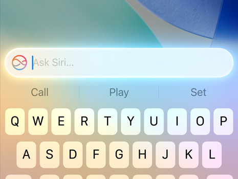 A close up of a cursor making a Siri request on macOS Tahoe.