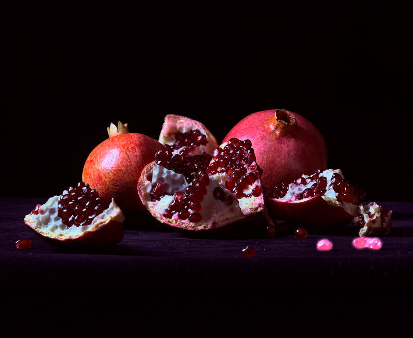 A close-up photograph of cracked-open pomegranates demonstrates the Clean Up feature, where unwanted objects in a photo are highlighted and deleted
