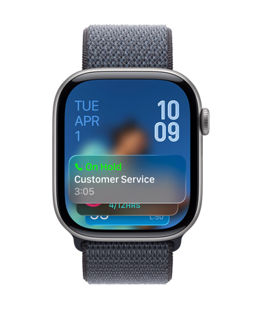 Apple Watch in Jet Black with Sage Band, Face shows Hold assist notification at bottom, date on top left, time numerals stacked at top right