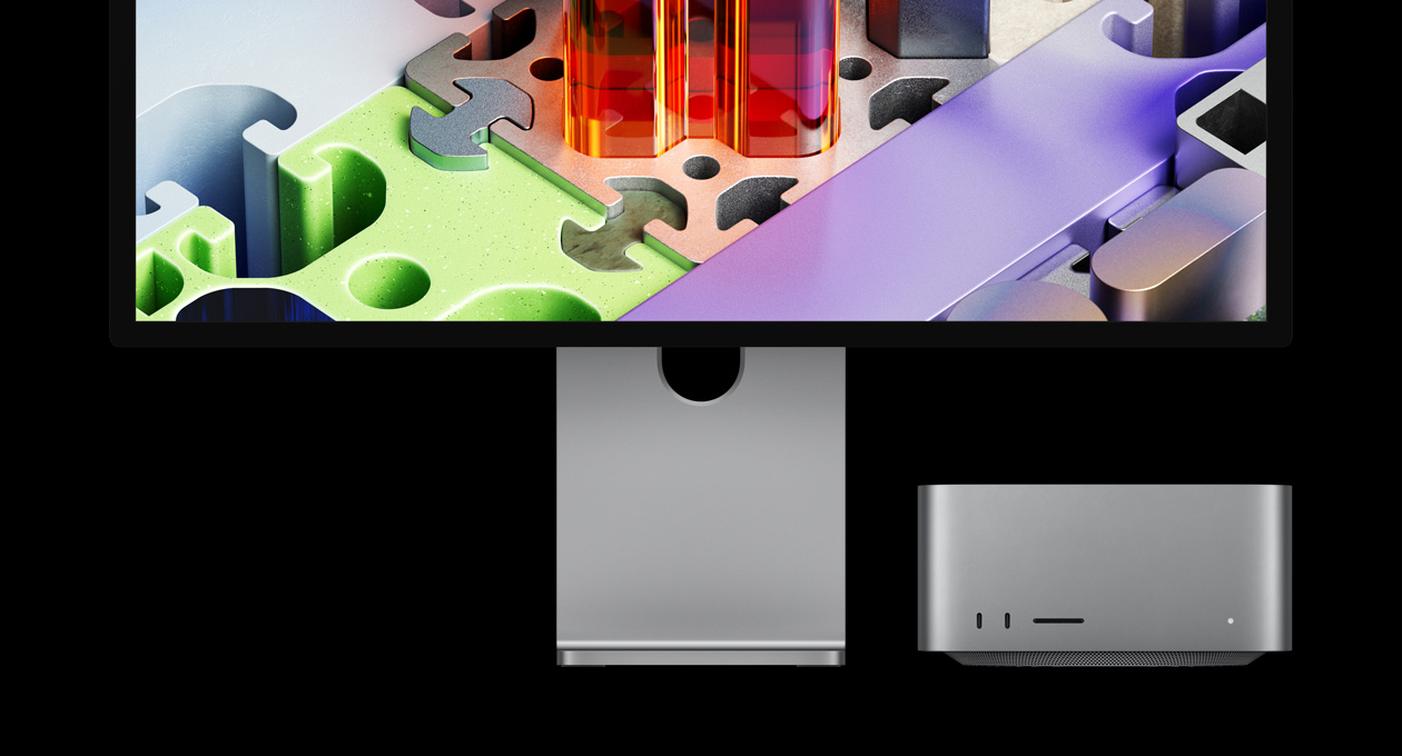 Mac Studio kombiniert mit Studio Display XDR, Gerät unter dem Display platziert; das Studio Display XDR hat ein dreidimensionales Hintergrundbild, das einem Puzzle ähnelt